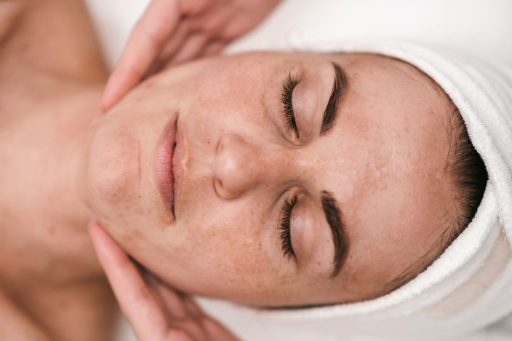 Close-up of professional facial treatment with client receiving skincare services.