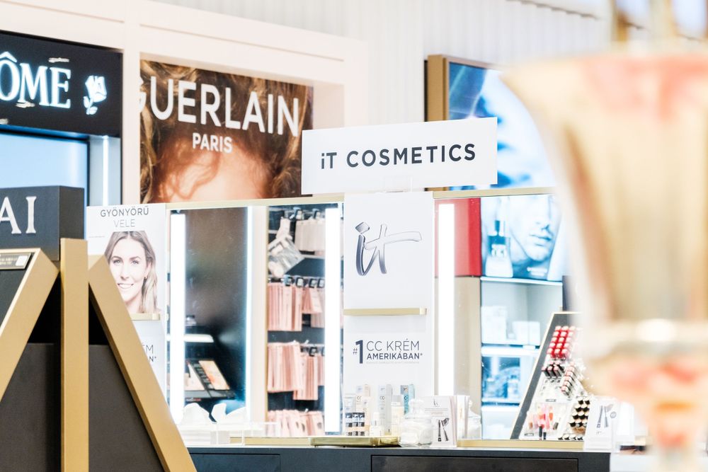 Interior view of a luxury cosmetics retail store with branded displays and signage.