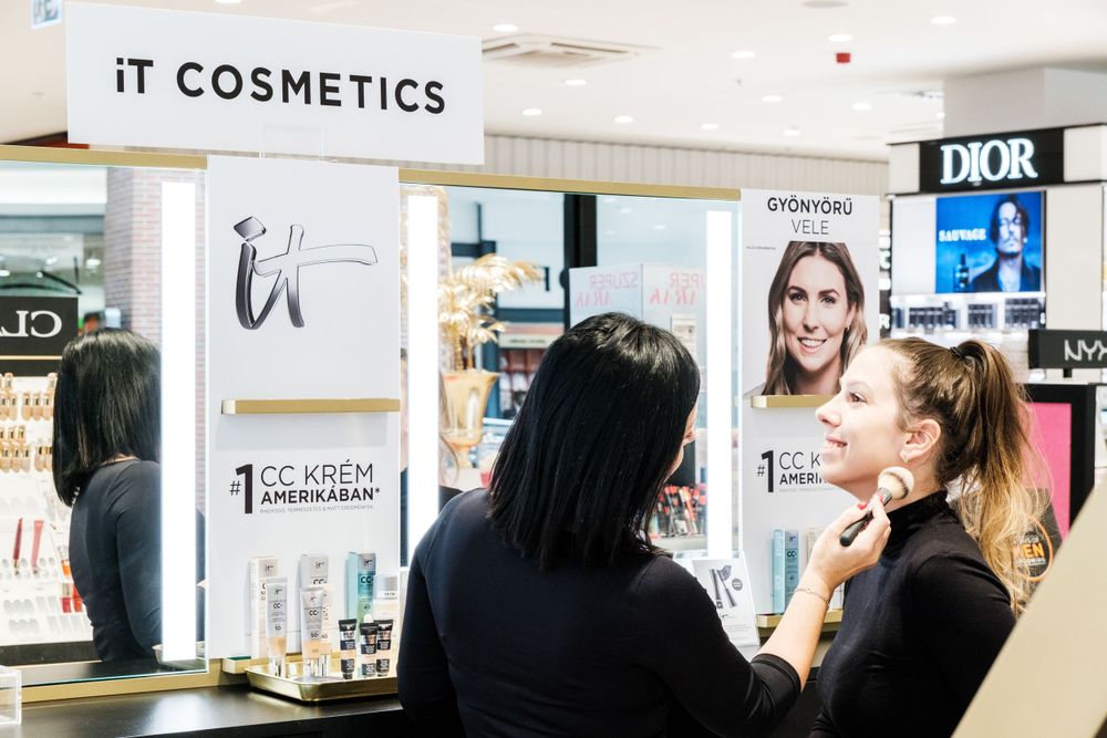 Beauty retail space featuring multiple brand displays including Dior and IT Cosmetics.