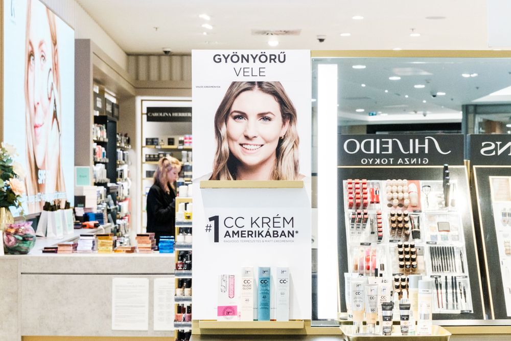 Modern retail store interior with cosmetics displays and bright lighting.