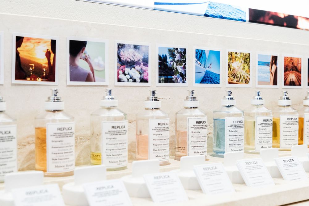 Row of white fragrance bottles arranged in a product display line.
