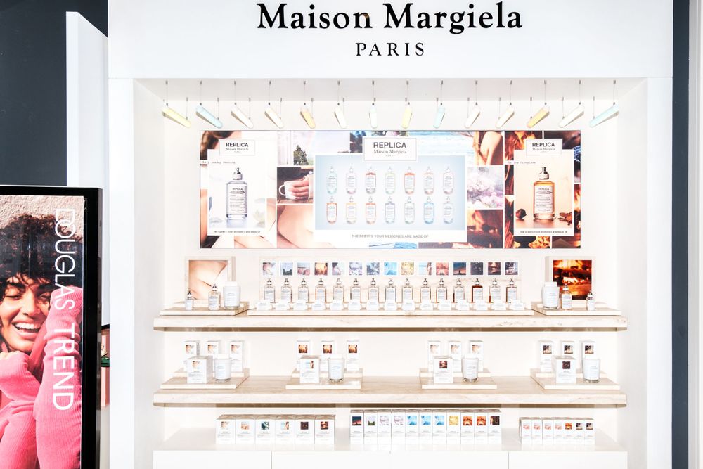Maison Margiela luxury perfume retail display with white minimalist design.
