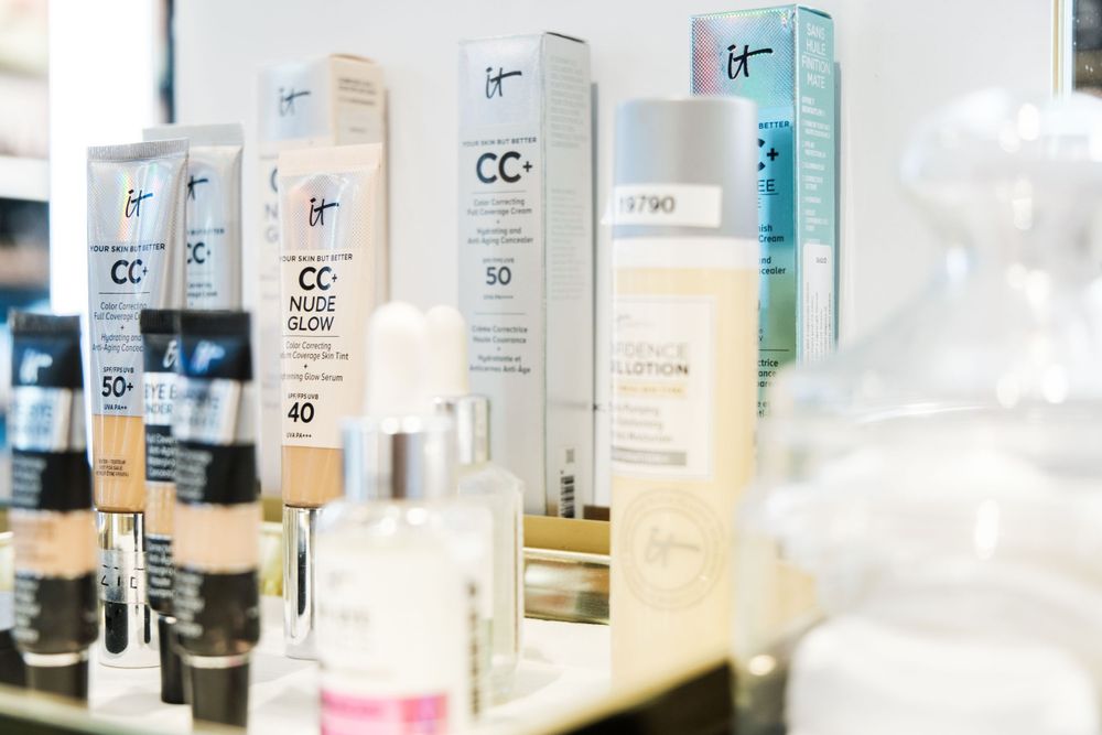Row of CC cream and skincare products displayed on retail shelving with clear labeling.