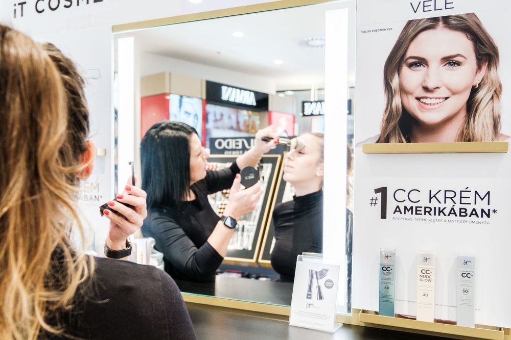 Modern cosmetics store interior with branded displays and customer service area.