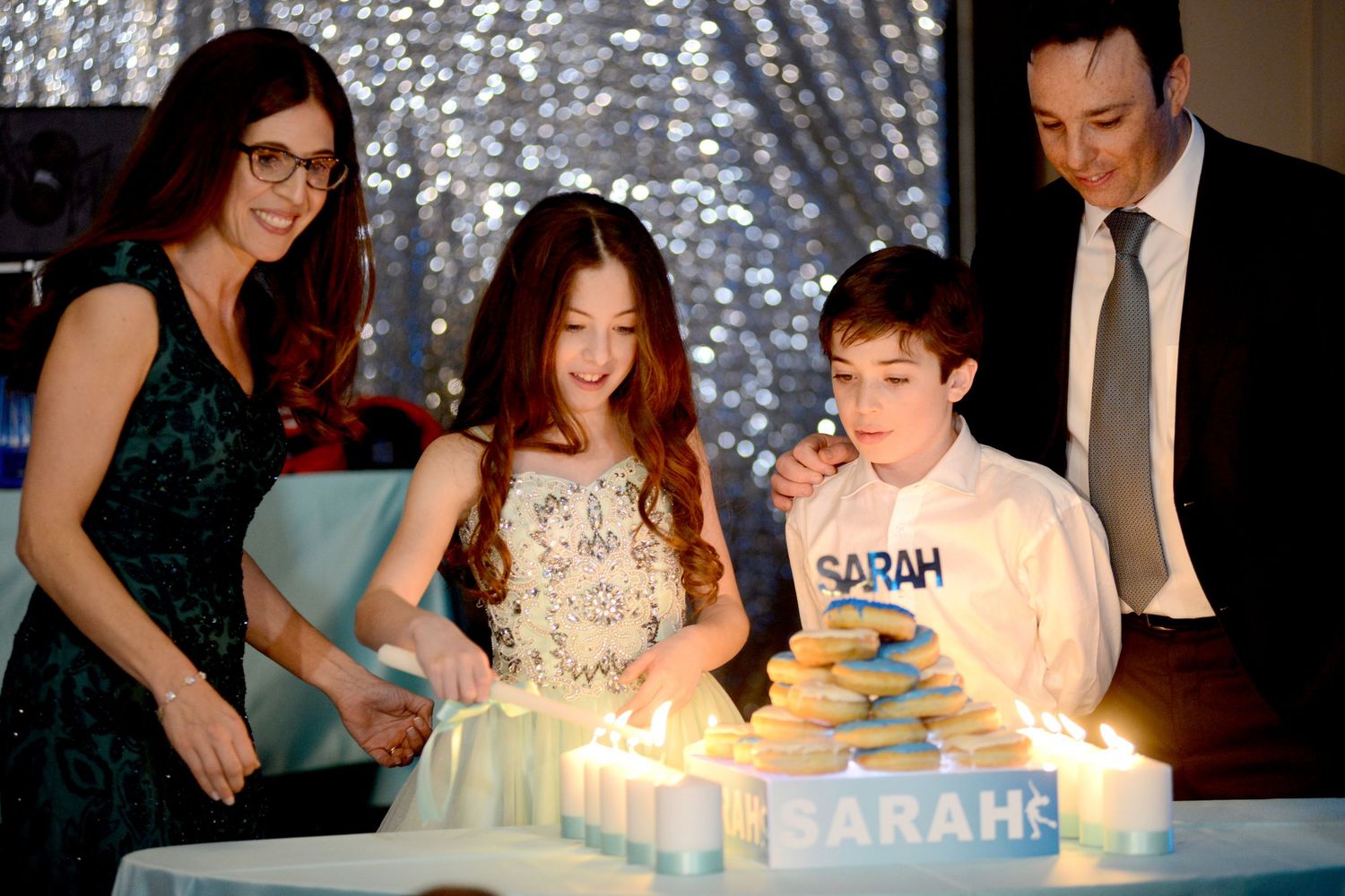 A sequence of birthday celebration photos showing lit candles on a cake being blown out in a dimly lit room.