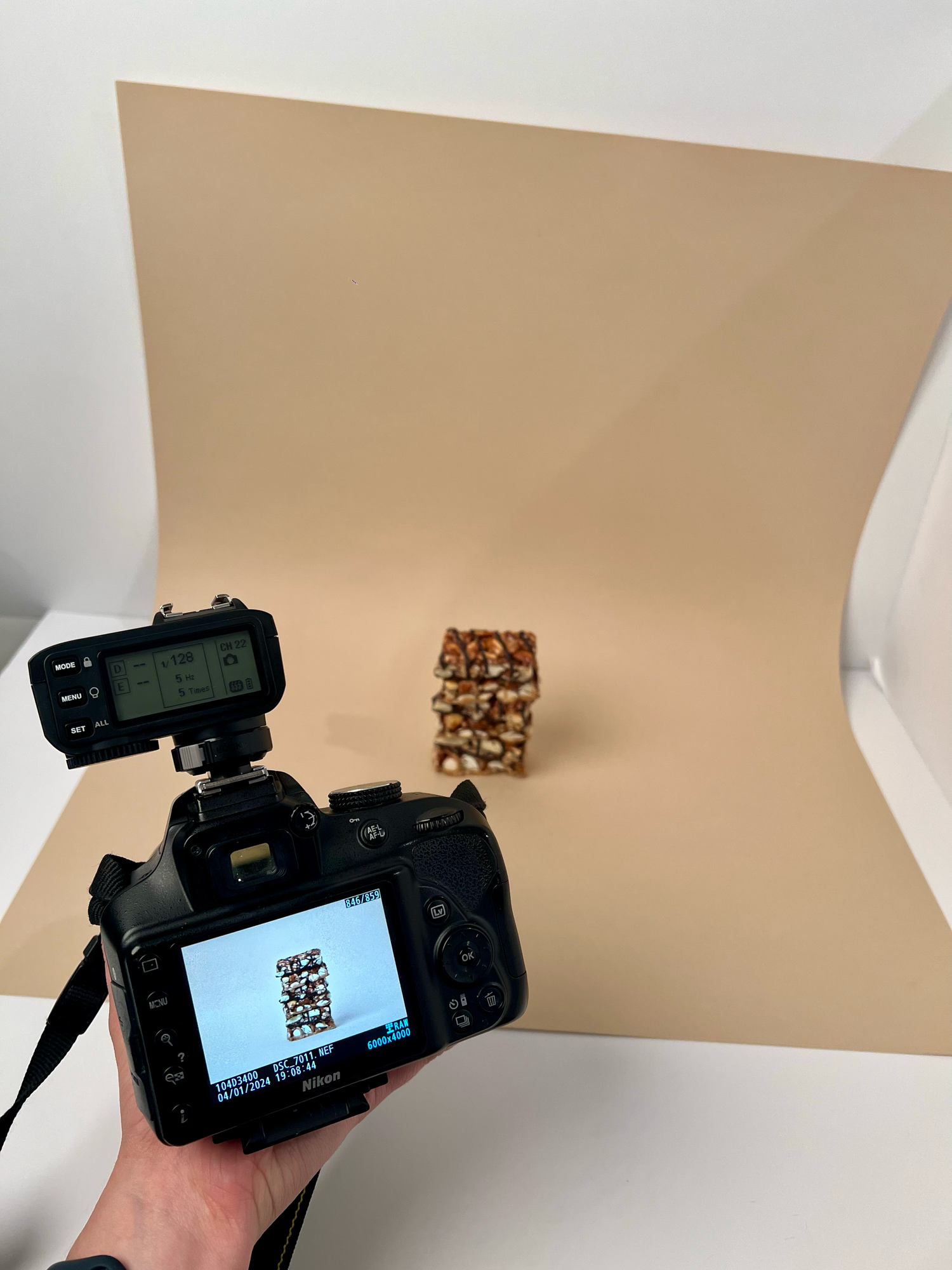 Camera setup photographing a QR code with white backdrop in studio setting.