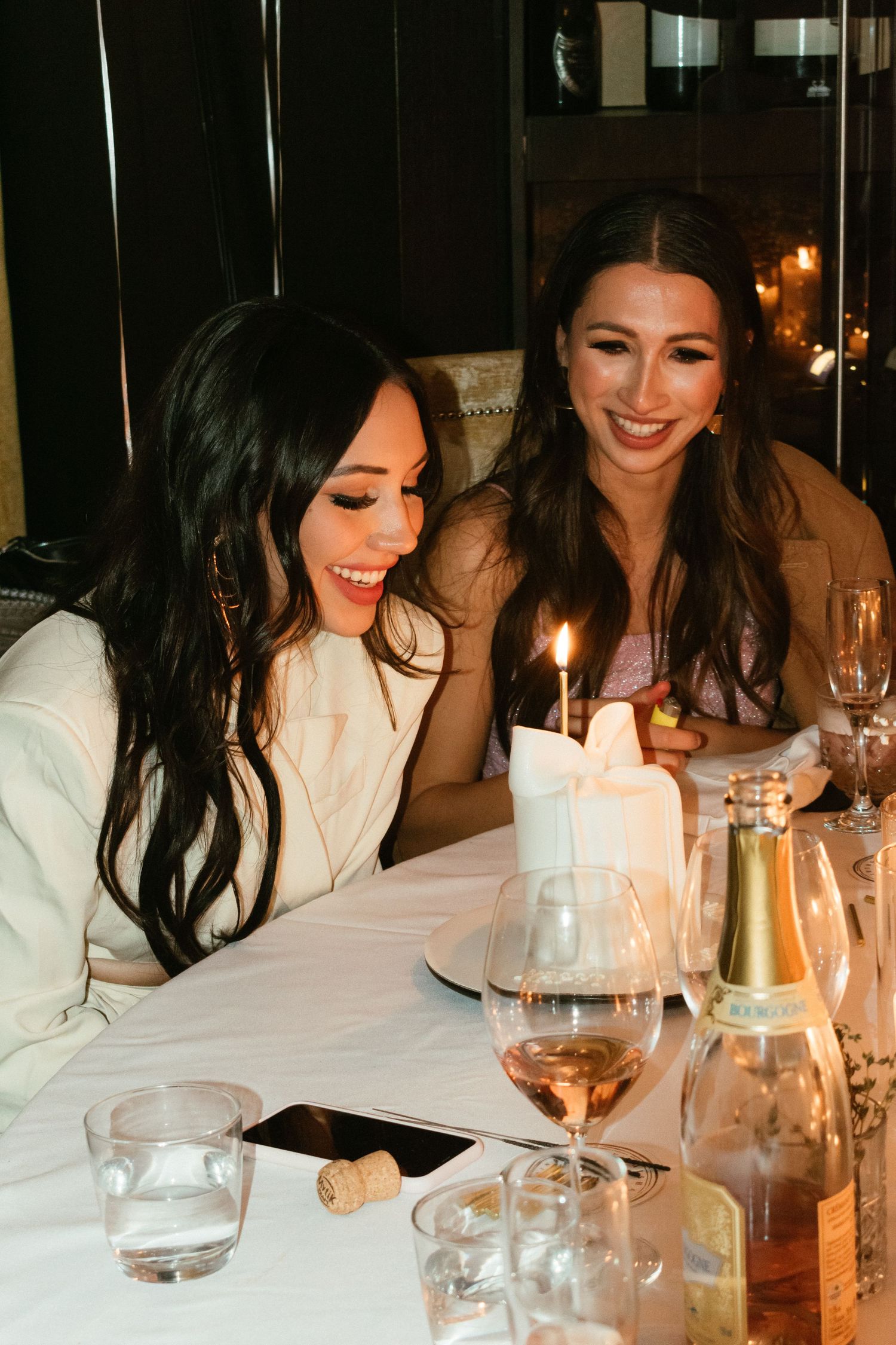 women blowing out a candle at her birthday party