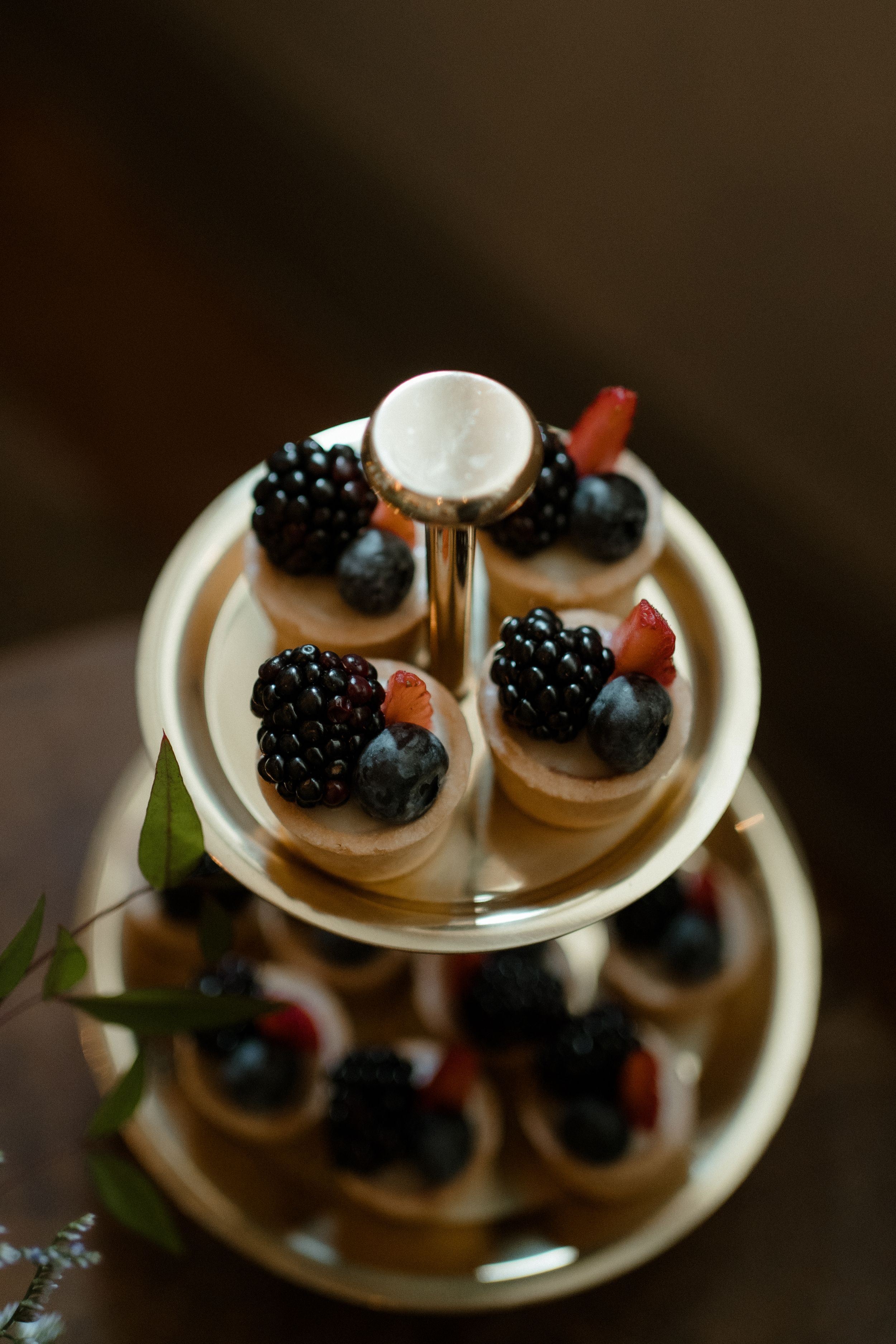 Dessert plate with fresh berries and cream garnished with blackberries and raspberries.