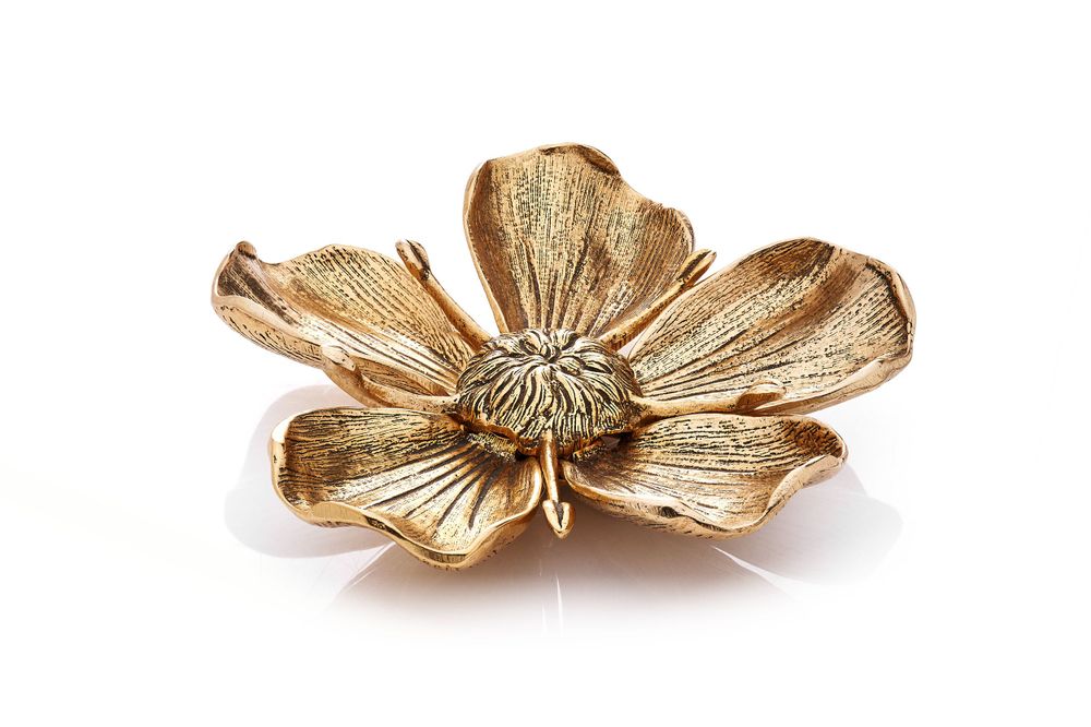 Golden flower-shaped jewelry pieces arranged in a row on a white background.