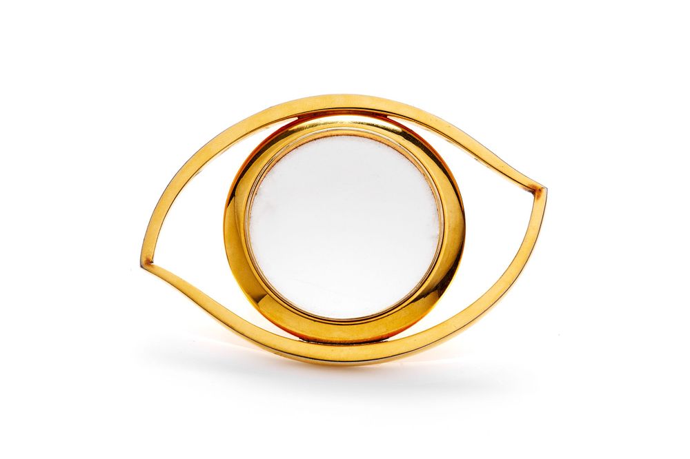 Stylized golden eye-shaped jewelry pieces or decorative elements shown in different positions.