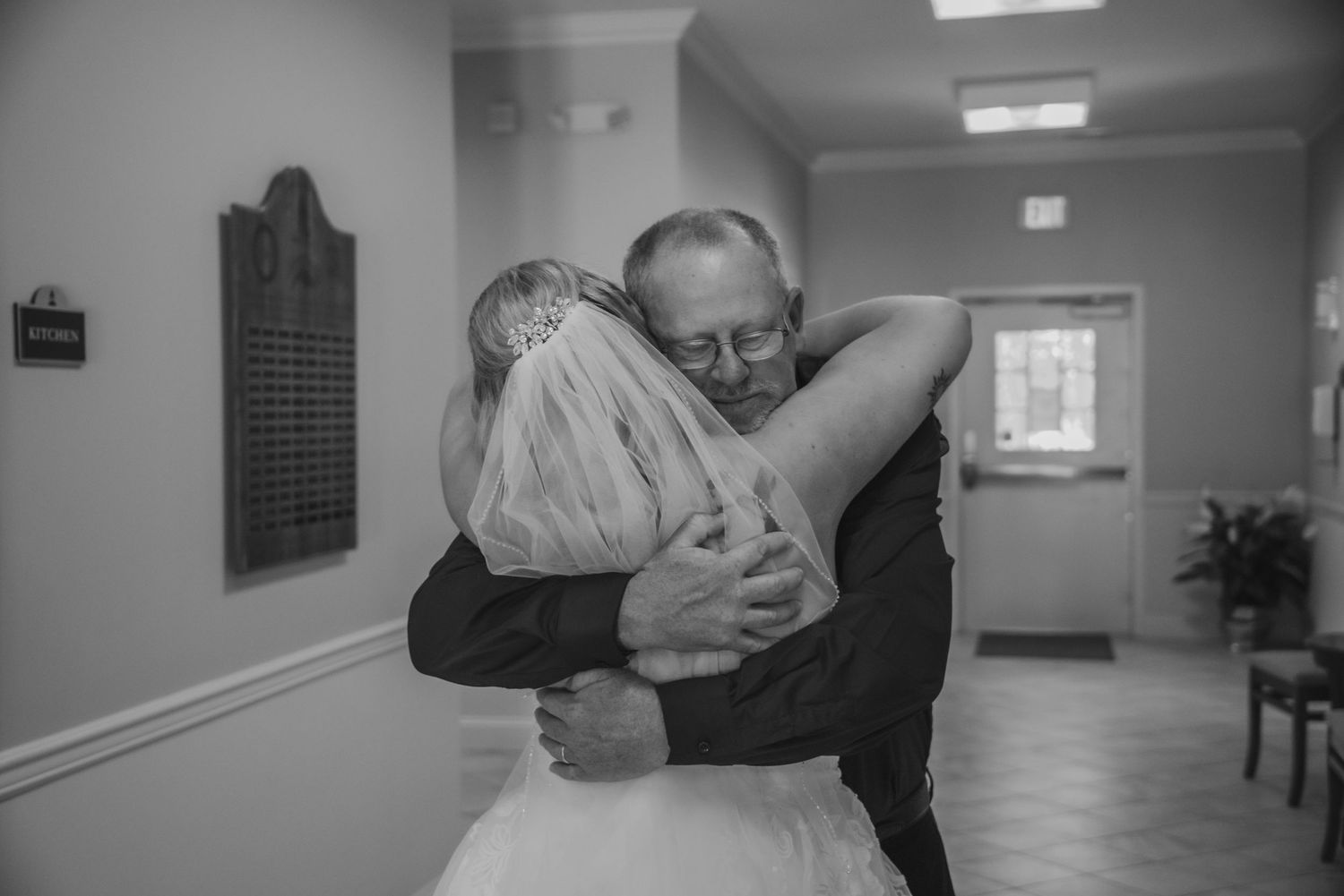 Father hugging bride on wedding day emotional