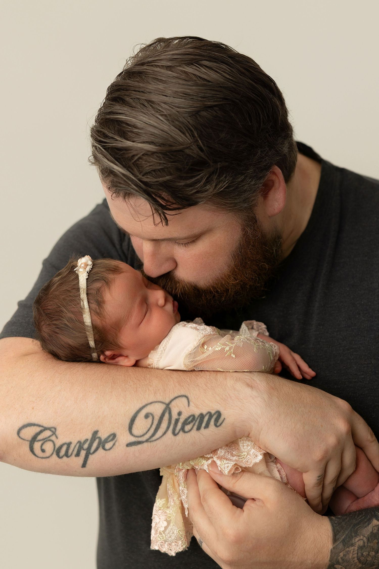 A set of four sequential photos showing the forearm with a carpe diem tattoo being covered by white bandage tape.