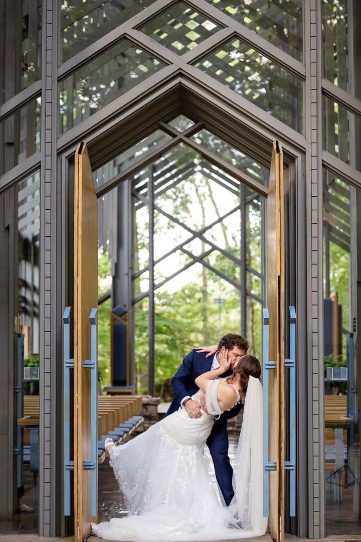 Bride and groom sharing a kiss inside Thorncrown Chapel in Eureka Springs, Arkansas