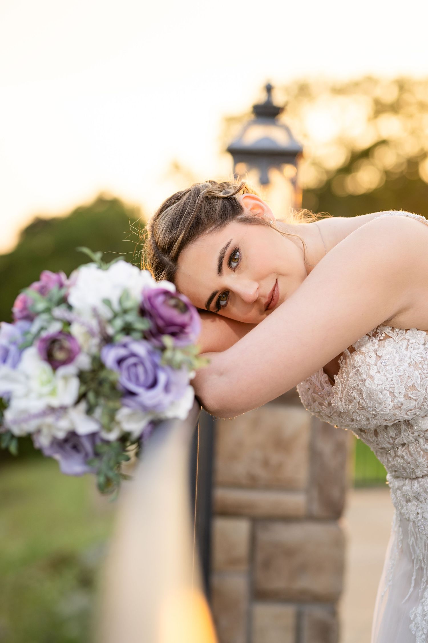 Bride resting with her lavender bouquet at golden hour, a Central Arkansas wedding