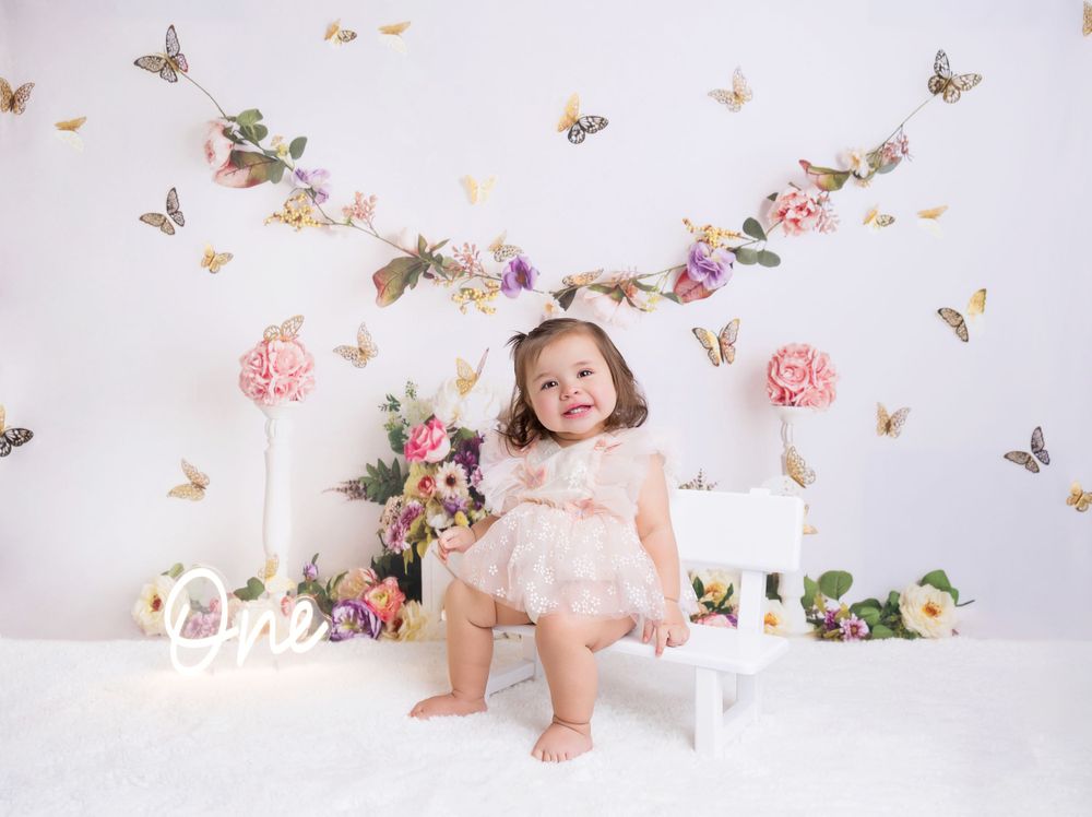 Romantic birthday setup with butterflies, flowers and soft lighting.