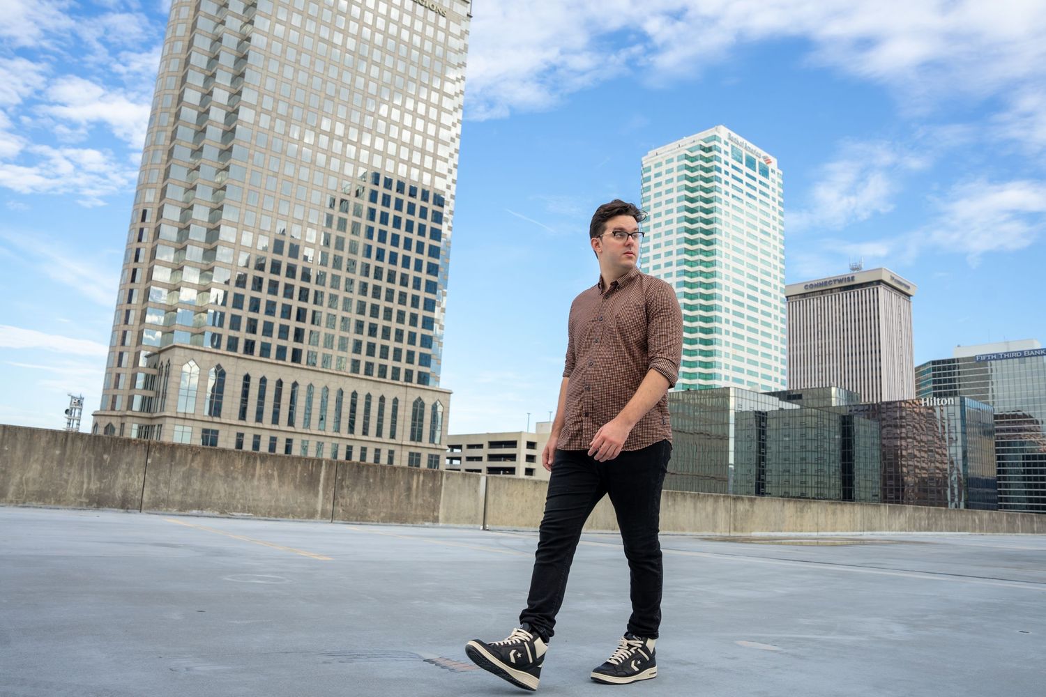 Urban photoshoot sequence with city buildings and skyline in background.