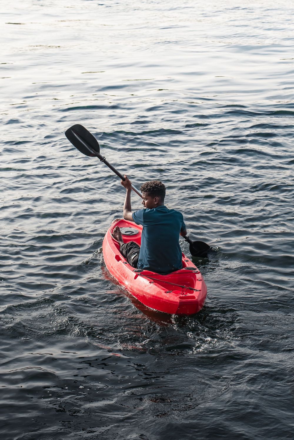 Egyptian kid kayaking on the nile in Aswan, Egypt