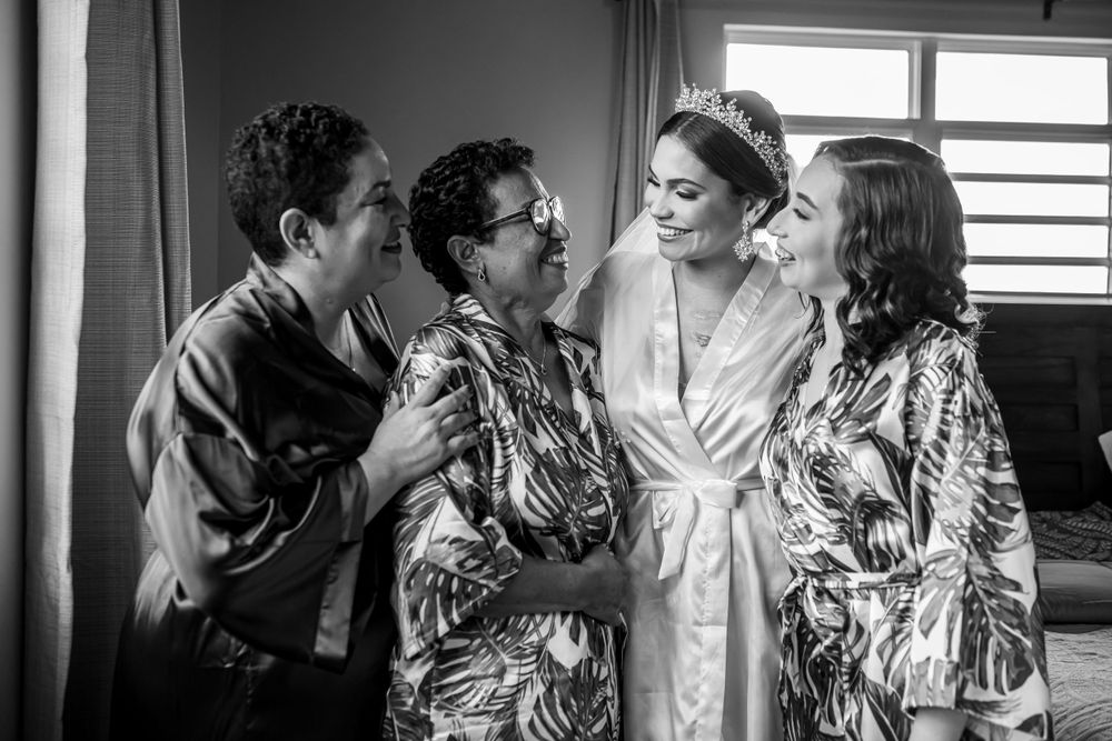 Candid interaction between bride and family during wedding preparations.