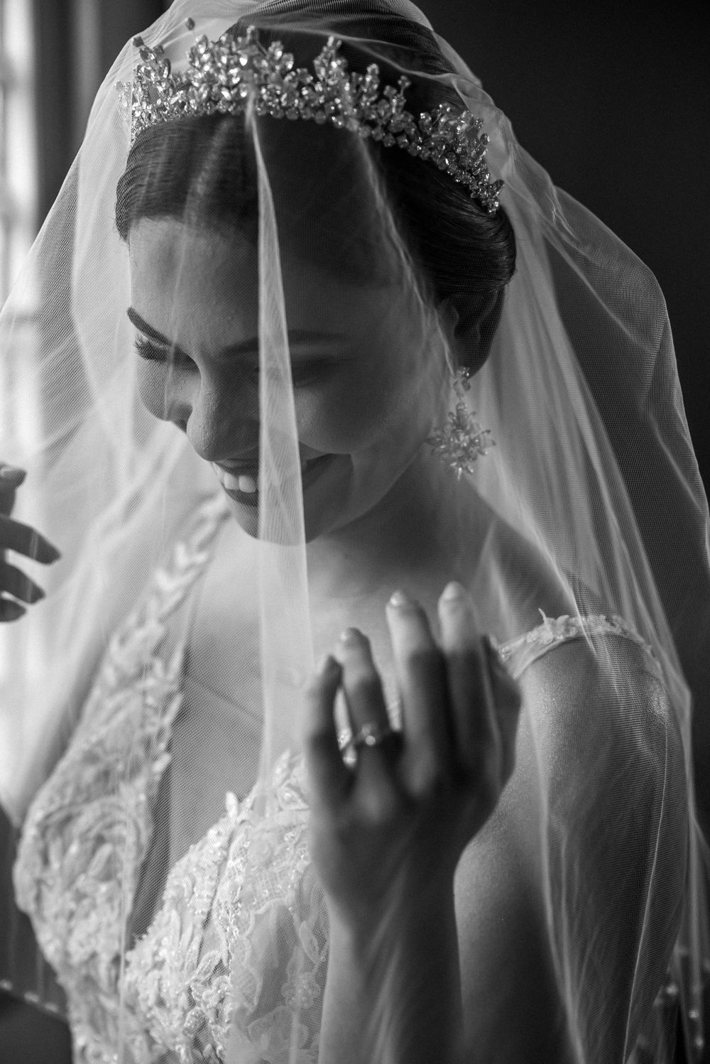 Artistic black and white shots of bride adjusting her veil.