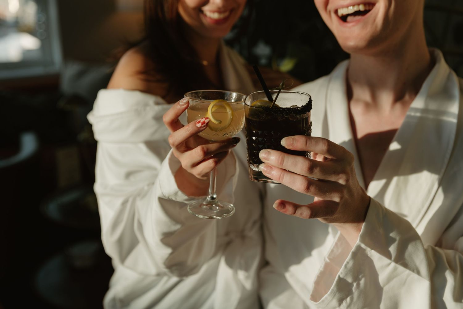 Detail shot of glasses clinking together during a photoshoot to promote an event in Wilmington, NC.