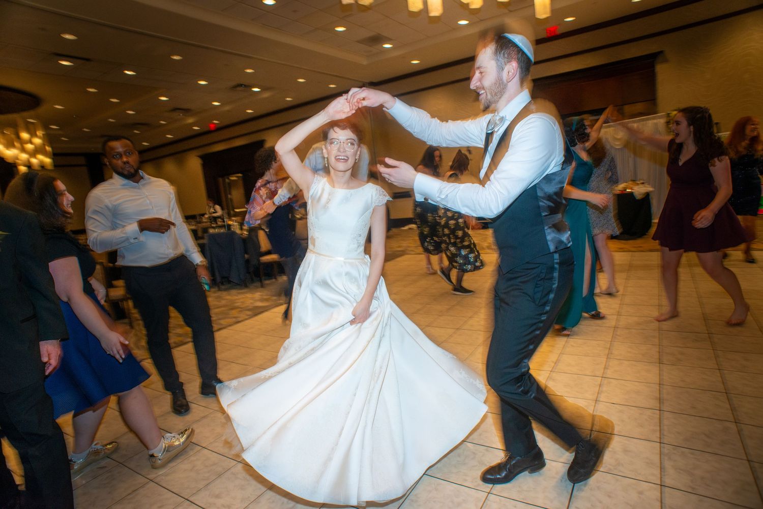 A lively dance moment during a wedding reception on a ballroom floor.