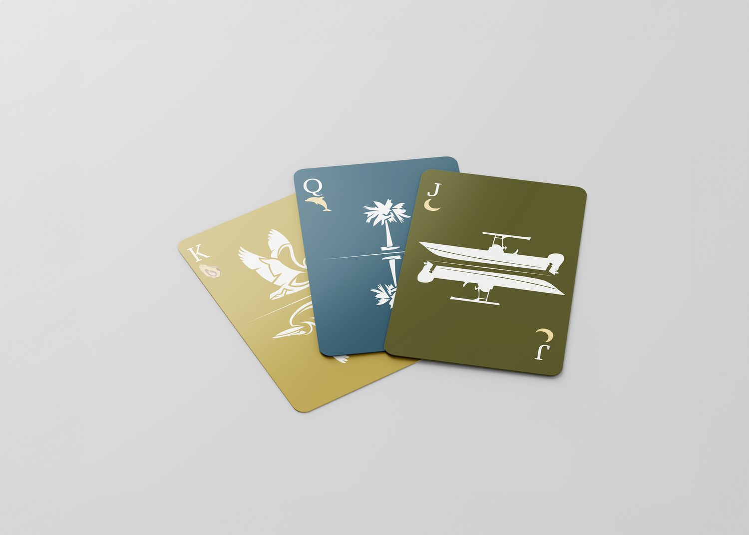 Three playing cards displaying palm trees and airplane designs in blue and gold colors.