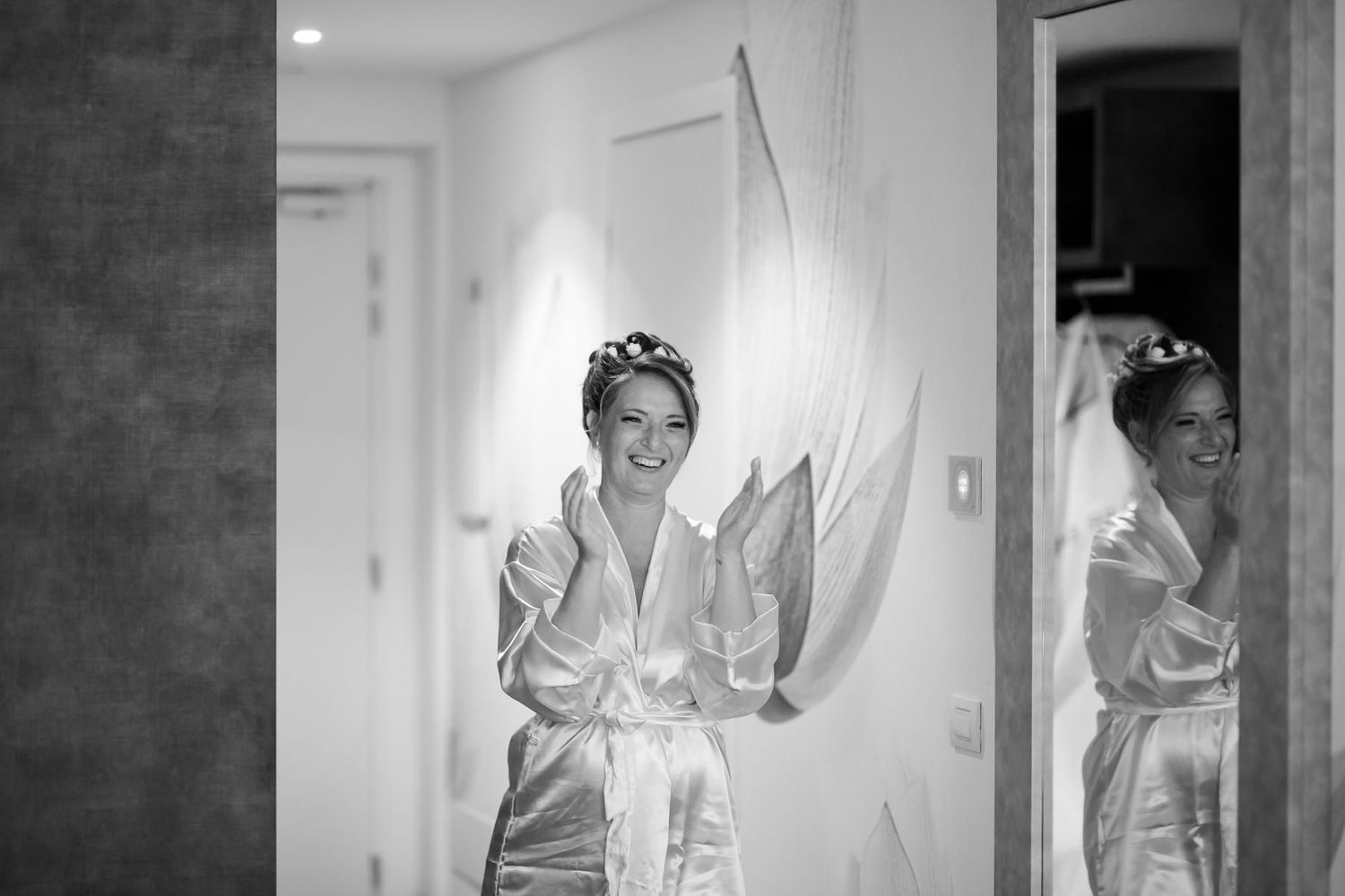 Wedding dress preparation captured in bright, airy indoor setting.