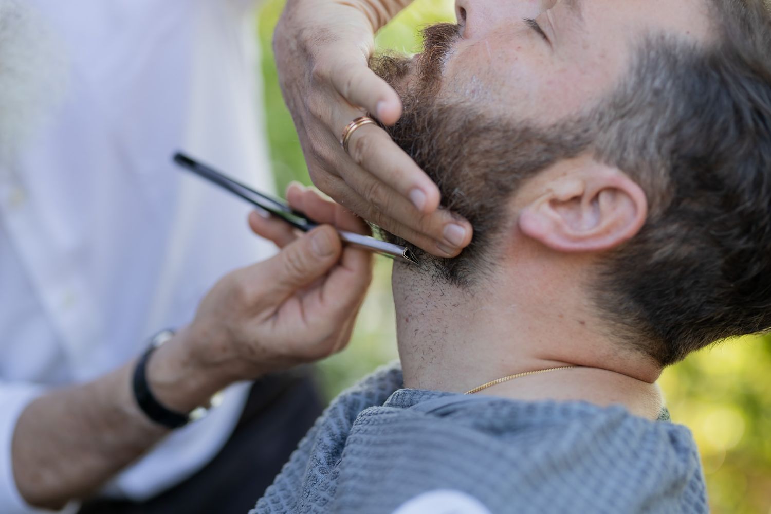 Close-up shots of beard trimming and grooming process.