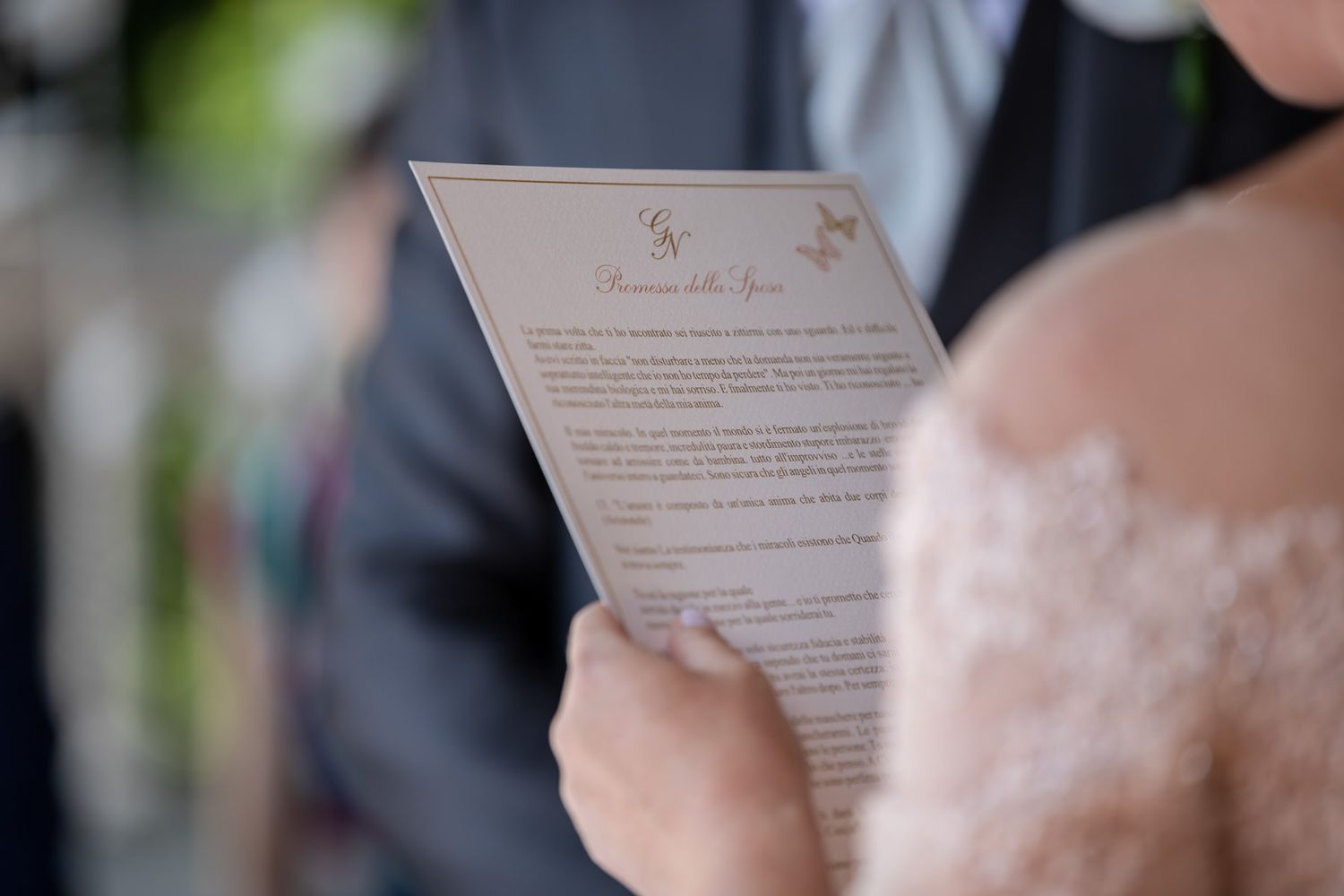Close-up of wedding ceremony programs being held during outdoor service.