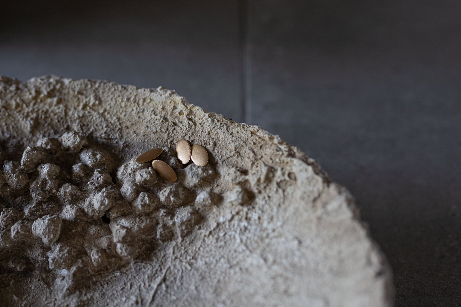 Artistic close-up of textured sand or powder against dark background.