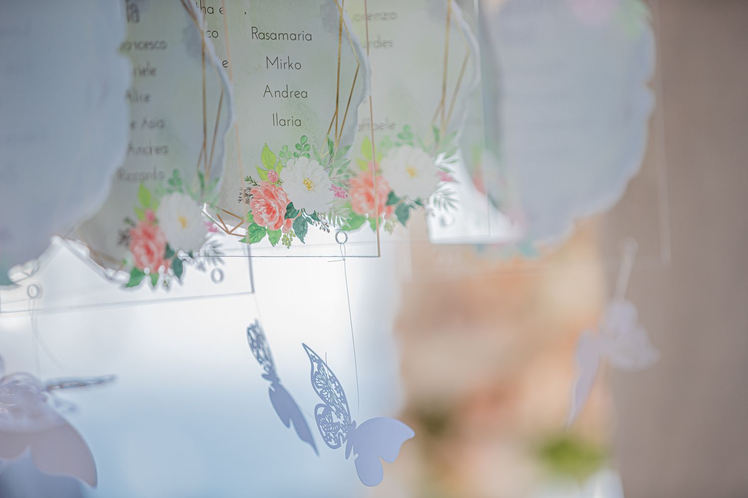 Soft focus wedding reception scene with decorative elements and natural lighting.