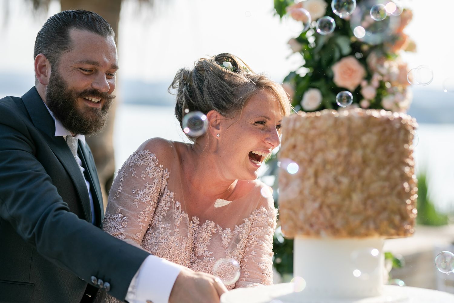 Wedding celebration with guests enjoying a lighthearted moment by the waterfront.