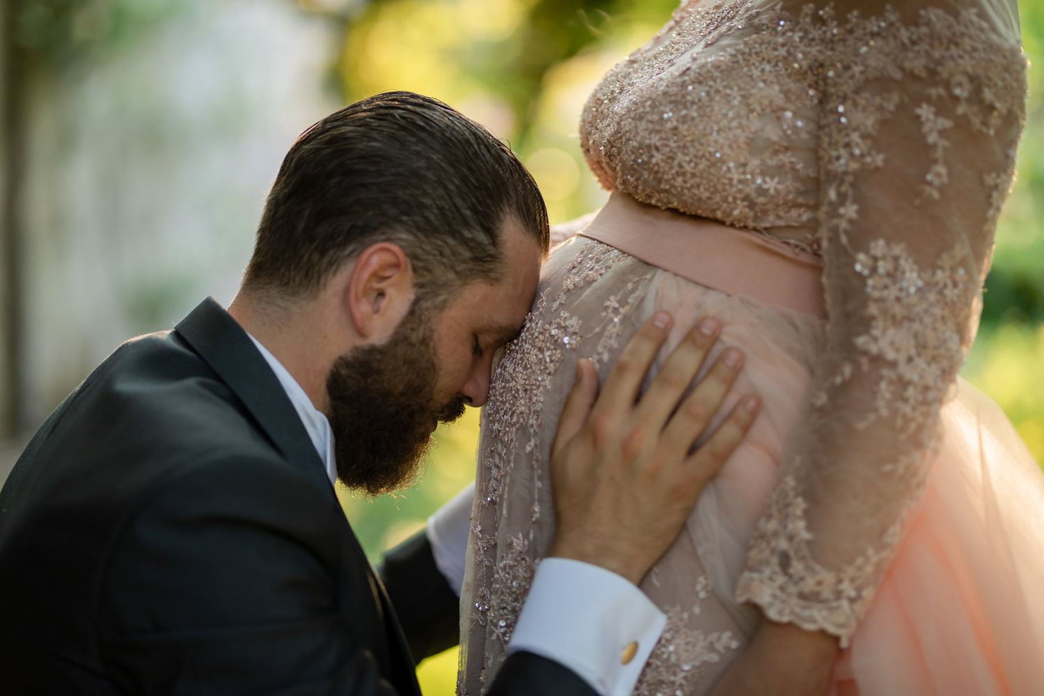 Intimate romantic moment captured between newlyweds in golden evening light.
