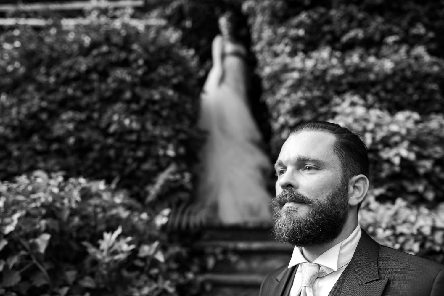 Black and white portrait series showing romantic moments in a garden setting.