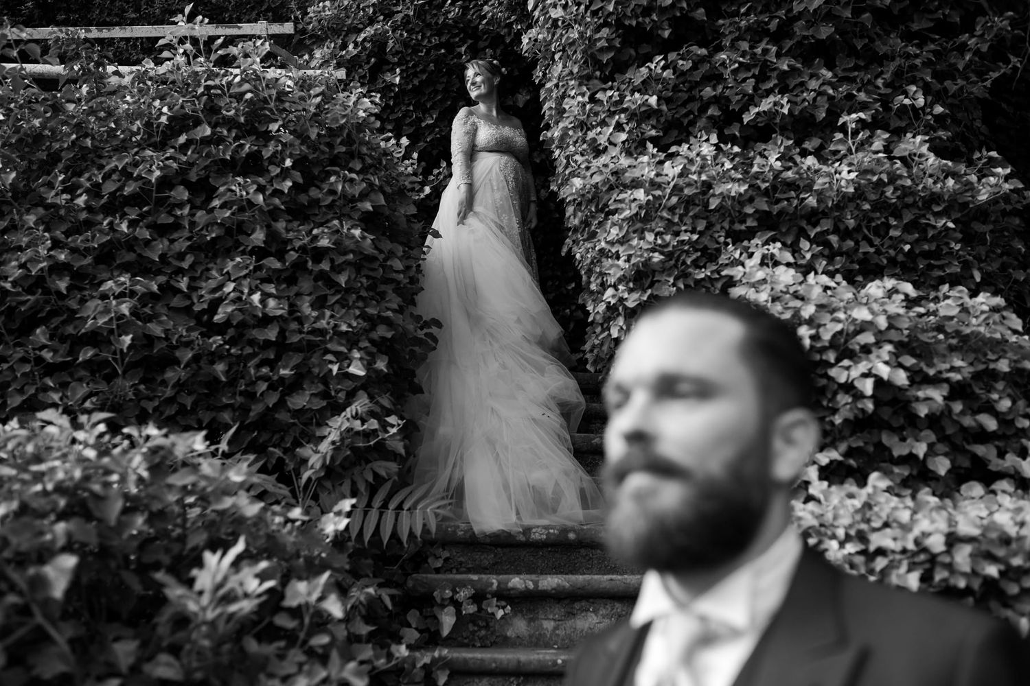 Black and white portrait photographs arranged in a horizontal sequence showing intimate wedding moments.