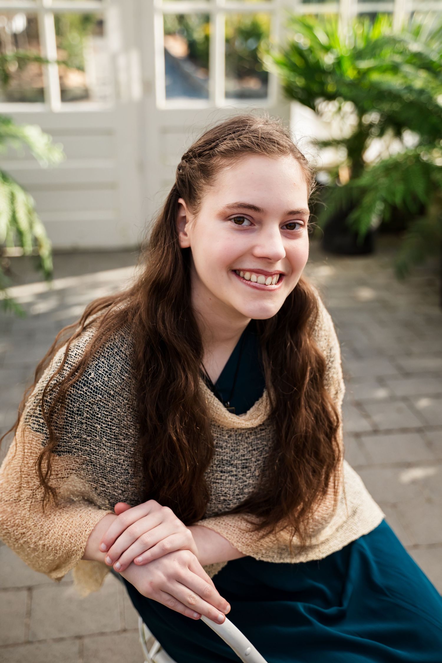 senior girl leaning on chair at Christianson's Nursery