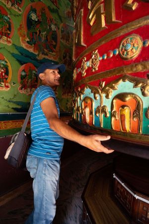 Colorful Buddhist temple interior with vibrant murals and traditional artwork.