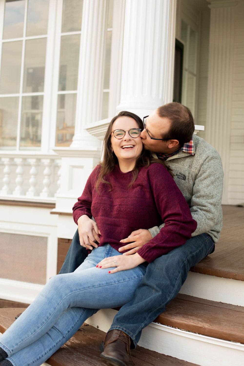 A playful series of moments shared on a white porch during an engagement photoshoot.