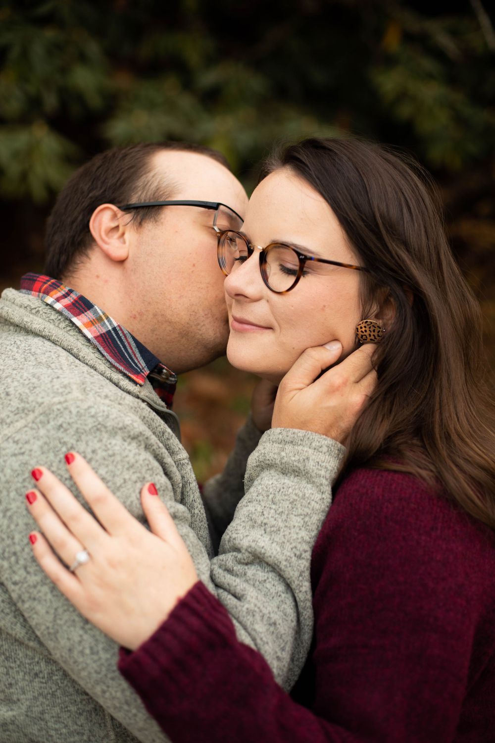 Romantic couple sharing an intimate moment while wearing casual sweaters.