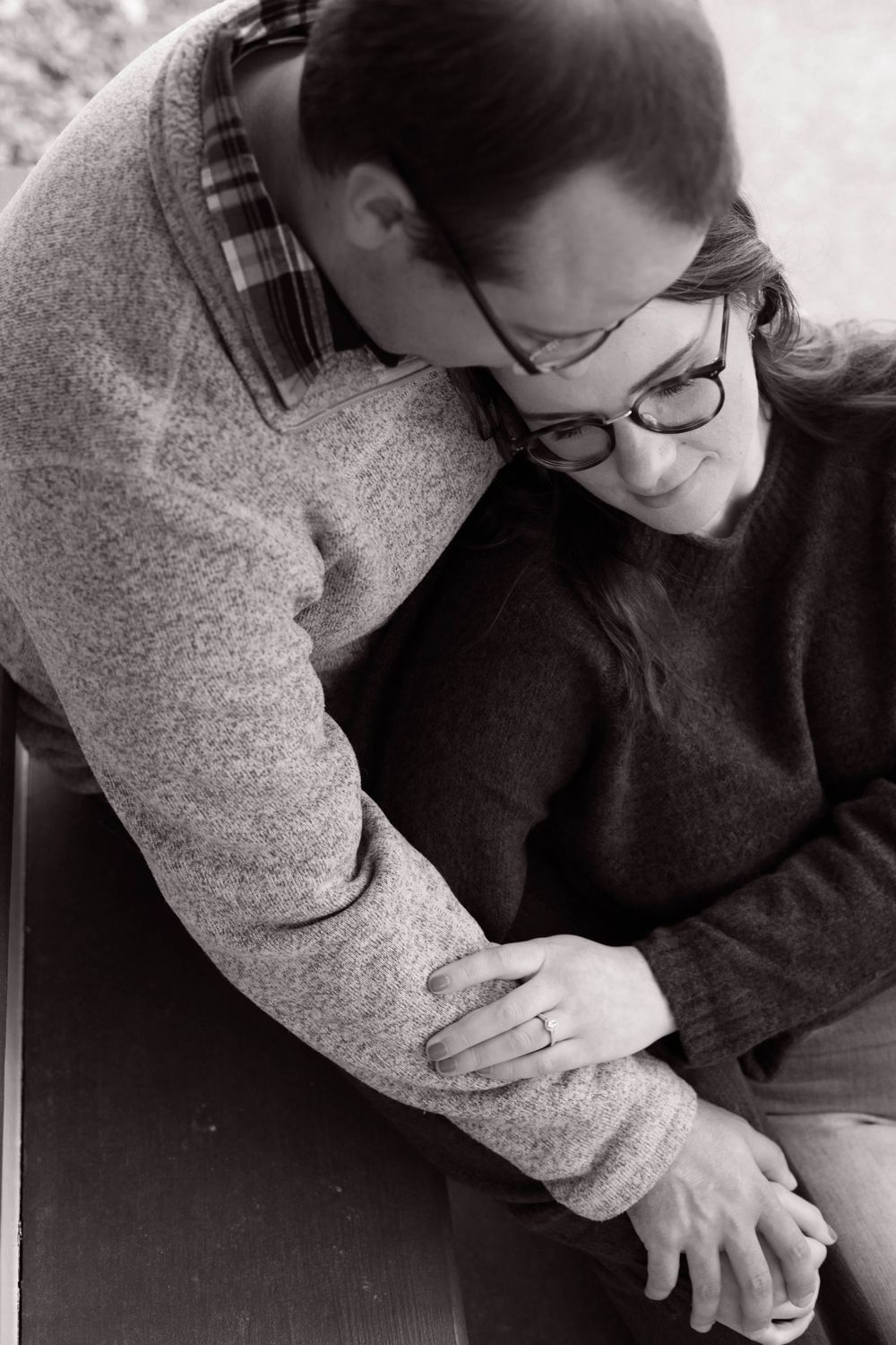 Artistic black and white photo of couple in casual sweaters.