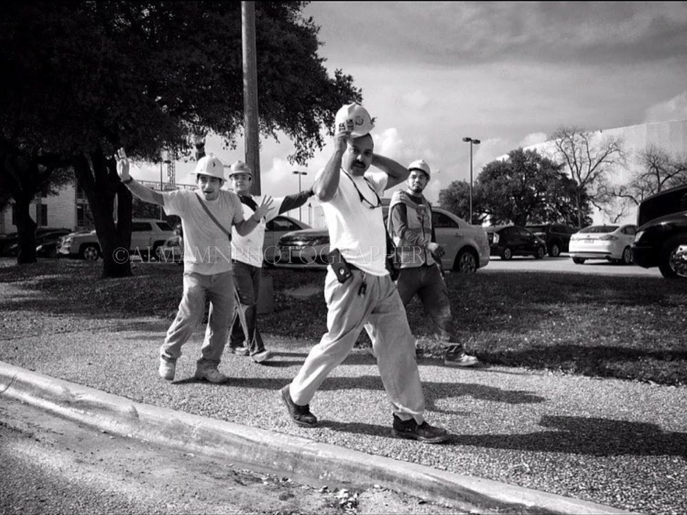 Group of people walking energetically on a street in black and white photography.