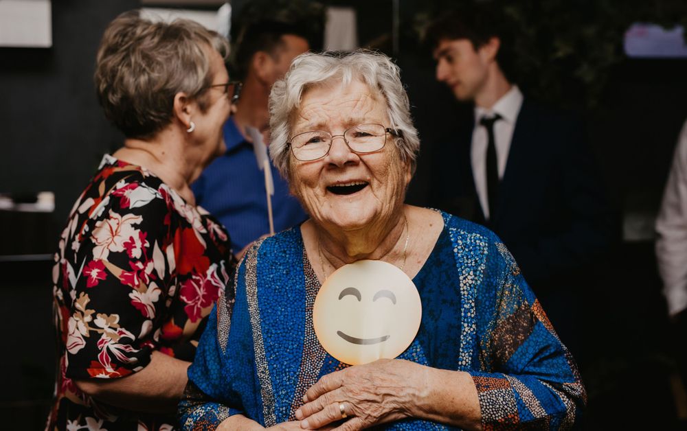 Joyful moment captured during wedding reception with genuine laughter.
