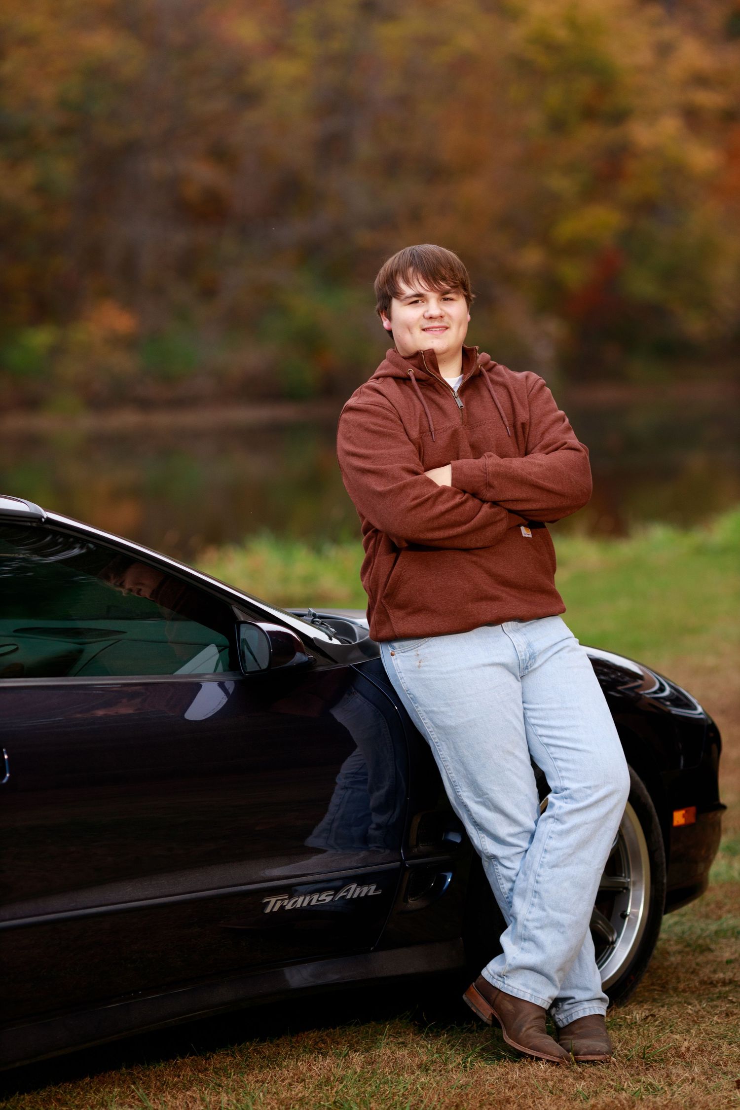 High school senior poses with his beloved car.