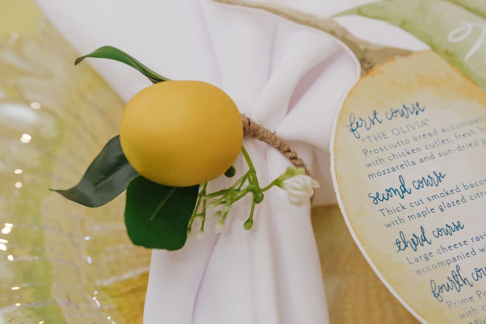 Lemon-themed wedding invitation suite with citrus illustrations and blue calligraphy text on white paper.