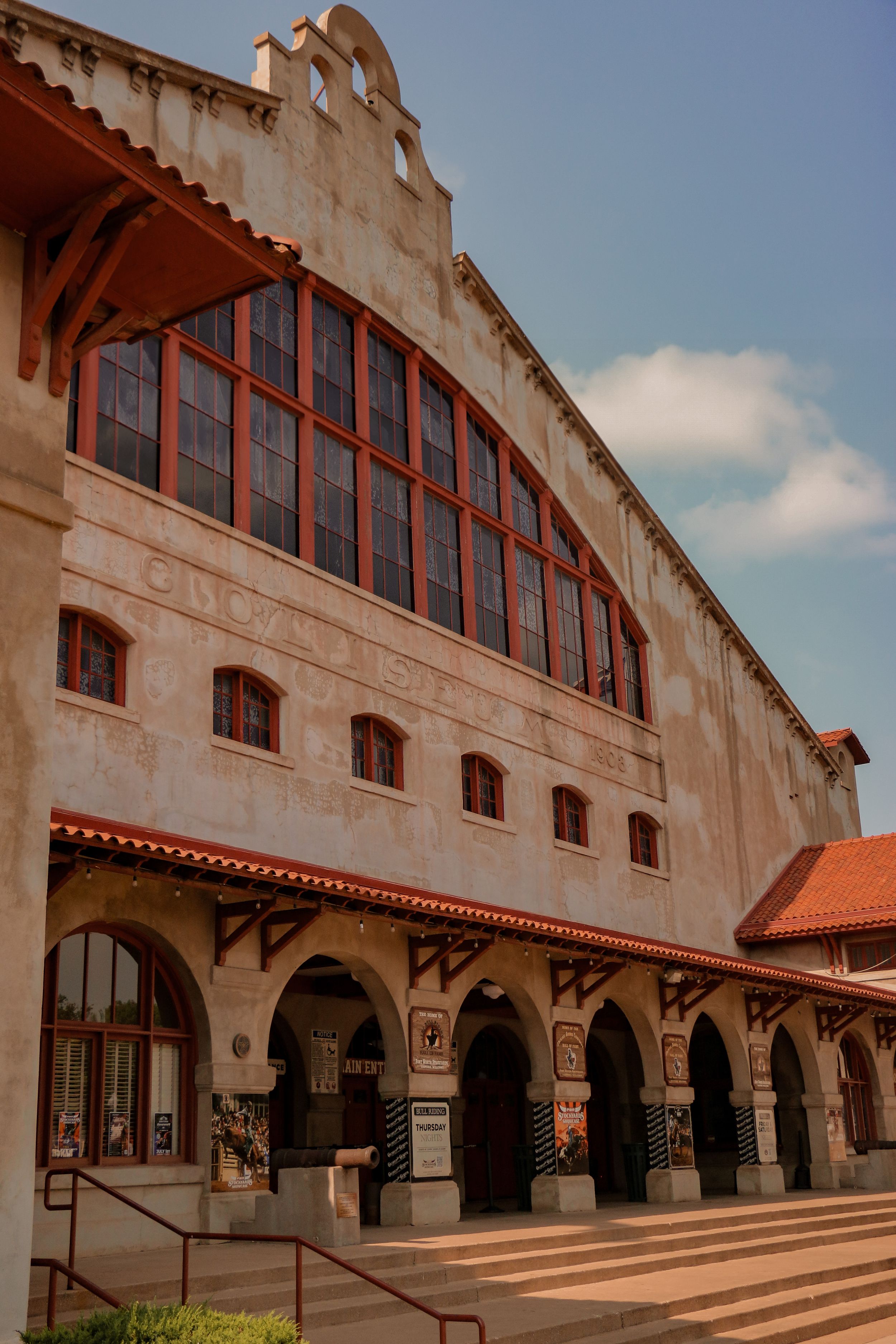 Historic Spanish colonial style building with large arched windows and terracotta roof.