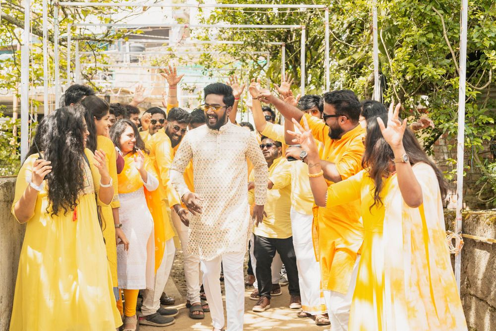 Group celebrating in matching yellow and white attire while walking together outdoors.
