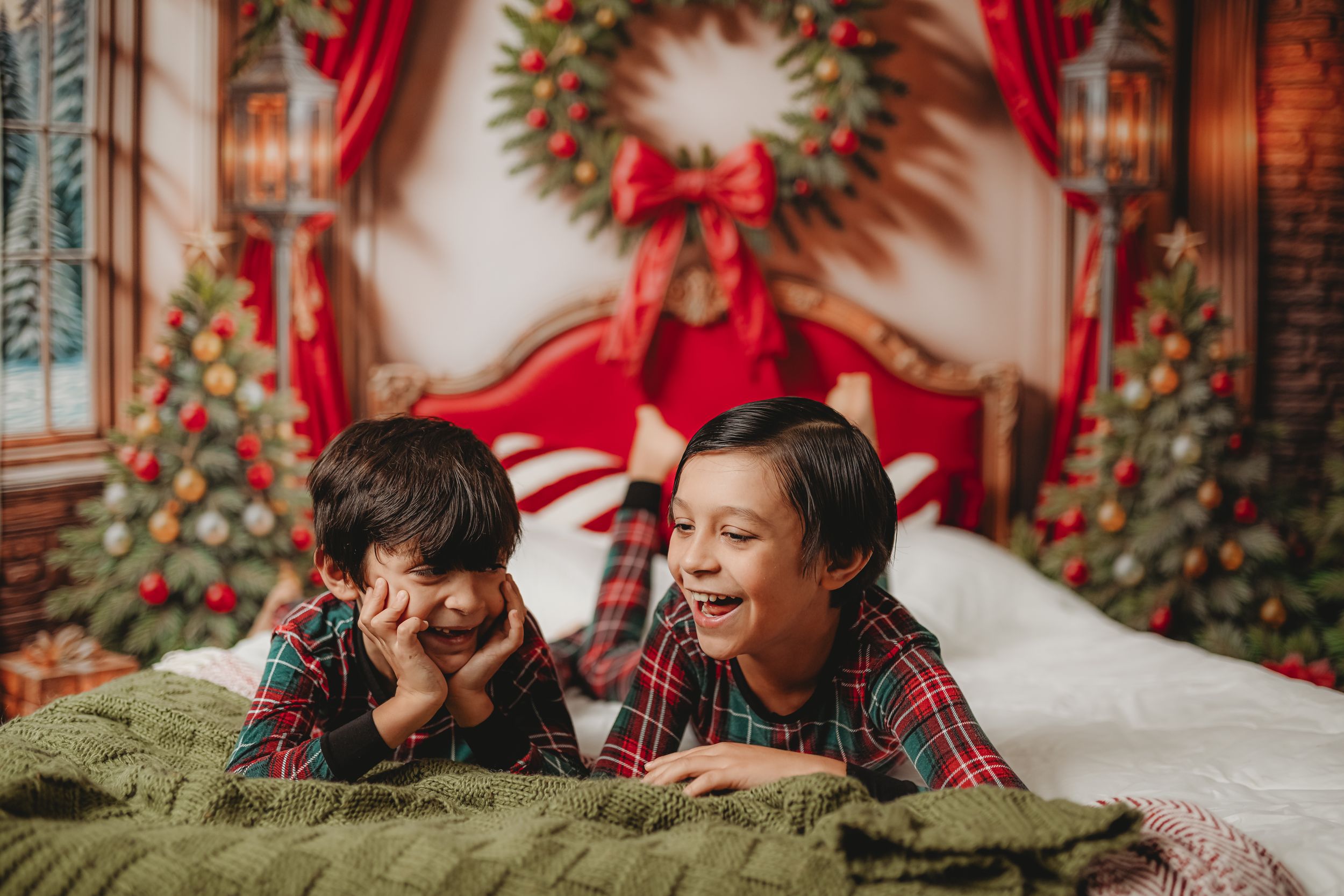 Holiday photo session setup with plaid outfits and Christmas decorations.