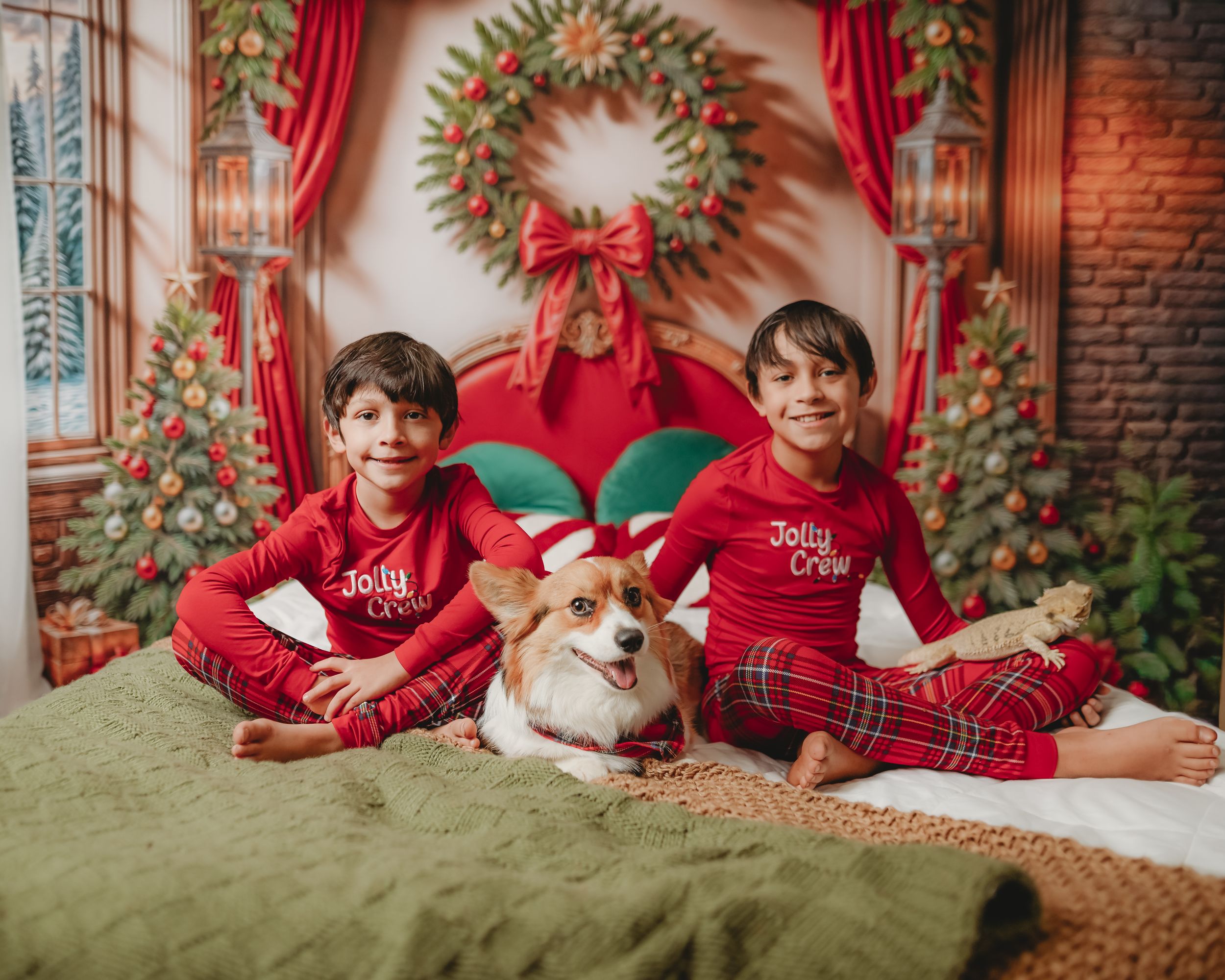 Festive Christmas scene with red curtains, wreaths and holiday decorations against exposed brick wall.