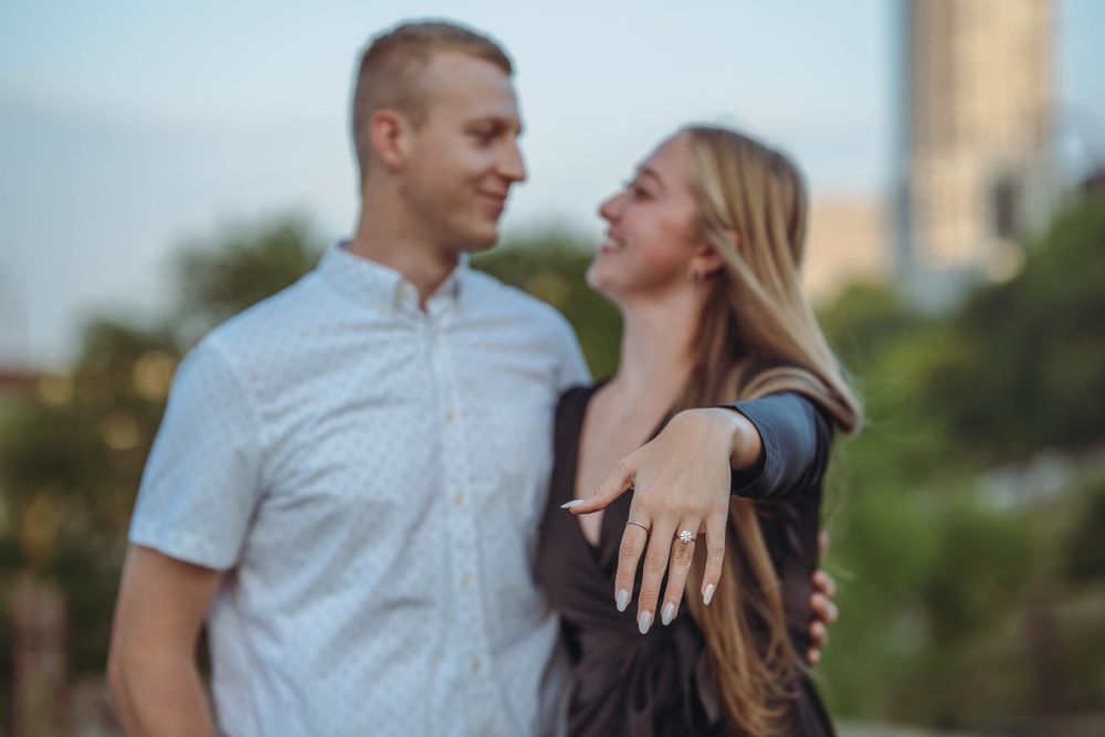 A couple holds hands affectionately, their intertwined fingers symbolizing love and unity