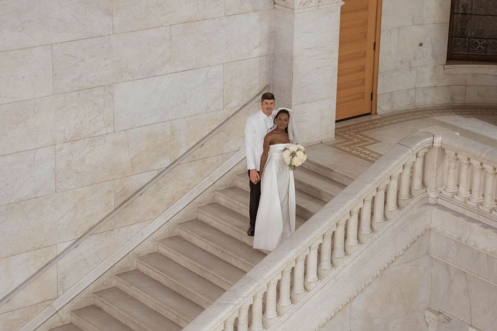 A bride and groom stand together, embracing on their wedding day, surrounded by love and joy